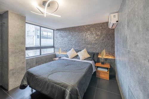 a bedroom with a bed and a ceiling fan at 3 bedroom apartment, one block from lleras park p12 in medellin in El Poblado