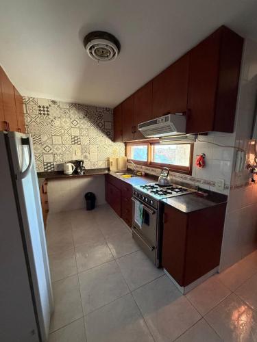 a small kitchen with a stove and a refrigerator at Departamento NILO in San Rafael