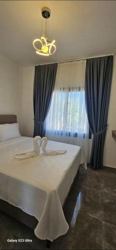 a bedroom with a large bed with blue curtains at Sunprime Premium Site in Pyla