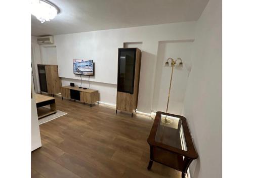 a room with a table and a television in a room at Apartments Sat in Belgrade