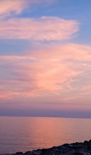 a cloudy sky over the ocean at sunset at Sunflower in Tavarone