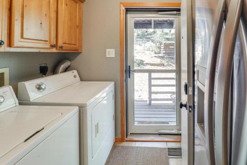 a kitchen with a washer and dryer next to a door at Families Welcome Quiet Cabin Less Than 5 Mi to Cloudcroft in Cloudcroft