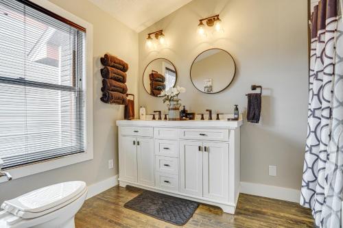 a bathroom with a toilet and a sink and a mirror at Walk to Bites and Whittier Park Uptown Getaway! in Minneapolis