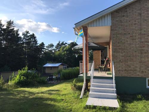 a house with a staircase leading to a patio at Alsterfors 23 