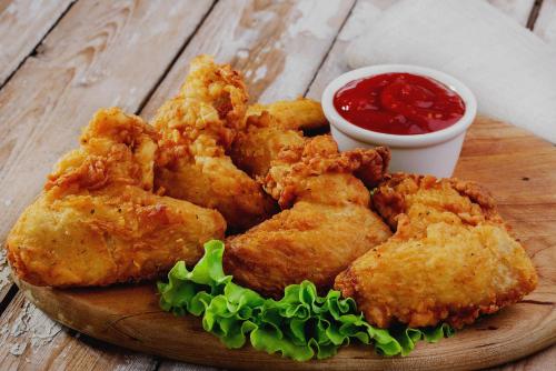 a plate of fried food with dipping sauce on a table at Super Hotel O New Cyber Grand Madhapur in Hyderabad