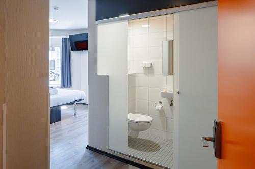 a bathroom with a toilet and a sink at easyHotel Zürich City Main Station in Zürich