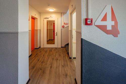 a hallway with a sign on the wall at easyHotel Zürich City Main Station in Zürich