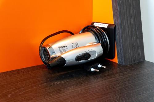 a hair dryer is hanging on a wall at easyHotel Zürich City Main Station in Zürich