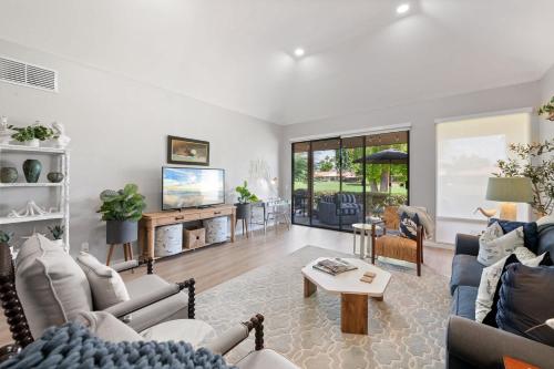 a living room with couches and a tv at Designer Seville Condo w Golf Mountain Views in Rancho Mirage