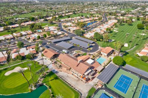 an aerial view of a community of houses with a pool at Designer Seville Condo w Golf Mountain Views in Rancho Mirage