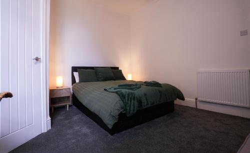 a bedroom with a bed with two lamps on it at Willin House Hotel in Blackpool