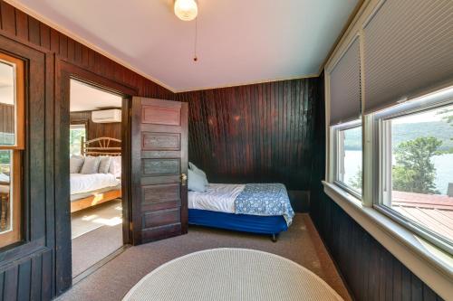 a bedroom with a bed and a window at Hatchs Landing Lake Ostego Home in Cooperstown