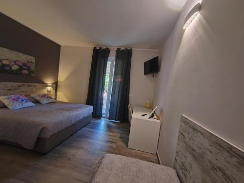 a small bedroom with a bed and a window at La perla del Garda in Costermano sul Garda