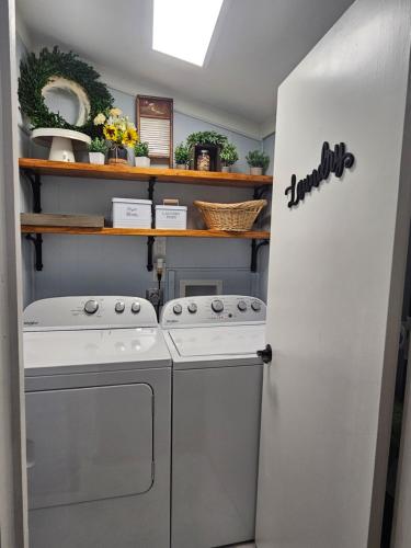 a laundry room with a washer and dryer at Historic Farmhouse - Tranquil Country Nature Escape in Hondo