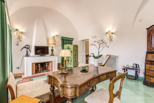 a living room with a table and a fireplace at Villa Calypso in Capri