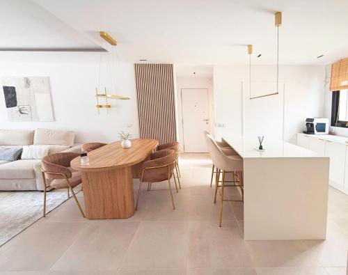 a kitchen and living room with a table and chairs at Luksusowy Apartament z basenem i jacuzzi in Málaga