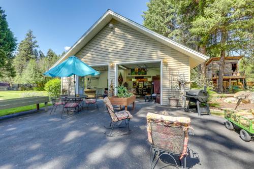 a house with a patio with chairs and a grill at Walk to Happys Inn Studio with Outdoor Space! in Libby
