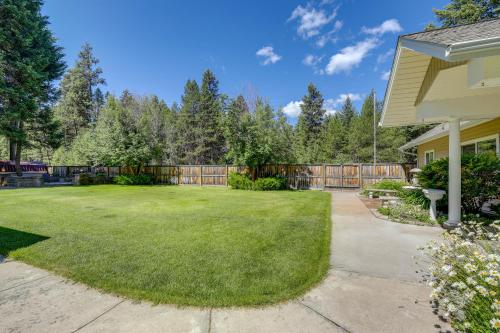 a backyard with a fence and a yard with green grass at Walk to Happys Inn Studio with Outdoor Space! in Libby
