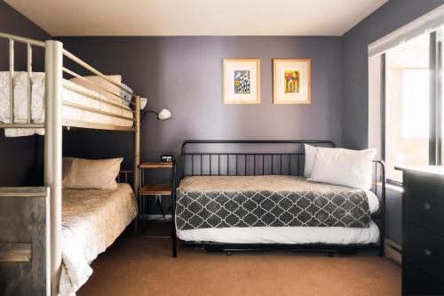 a bedroom with two beds and a bunk bed at Choice Condo - Walk to Gondola - Sleeps 7! in Avon