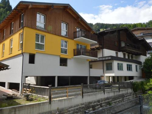 a house with a yellow and white building at Emma Top 1 in Dienten am Hochkönig