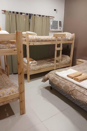 a room with two bunk beds and a fan at La FRANCESCA in Reconquista
