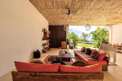 a living room with two couches and a table at Sukacita Hill in Uluwatu