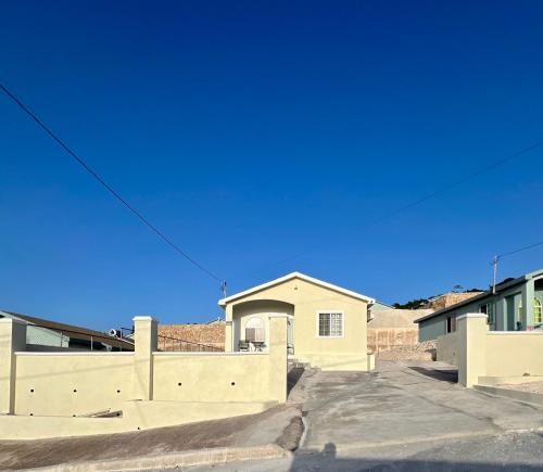 a house with a fence in a parking lot at OceanView Oasis in Discovery Bay