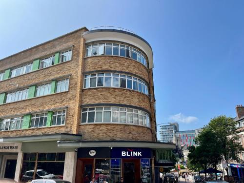 a tall brick building with a sign that reads billing at Bournemouth Nest in Bournemouth