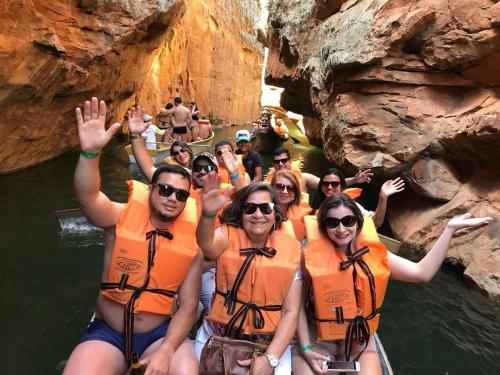 a group of people in the water on a raft at Pousada Flor de Lins in Piranhas