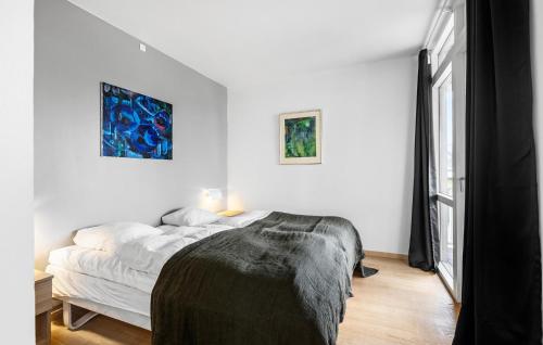 a white bedroom with a bed and a window at Gorgeous Home In Gråsten With Sauna in Gråsten