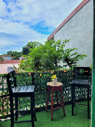 two chairs and a table on a balcony at Hostal Leyendas in León