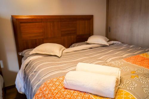 a large bed with two towels on top of it at HOM I SKI OUT 4PAX Edif Licancabur Valle Nevado 206A in Lo Barnechea