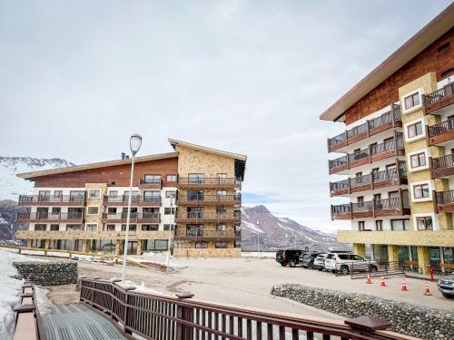 a large building with a parking lot in front of it at HOM I SKI OUT 4PAX Edif Licancabur Valle Nevado 206A in Lo Barnechea