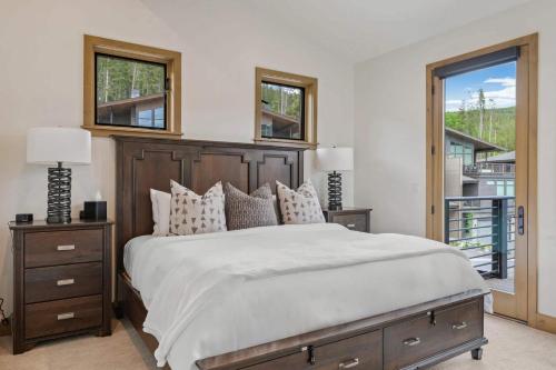 a bedroom with a large bed and a balcony at Apex Manor in Winter Park