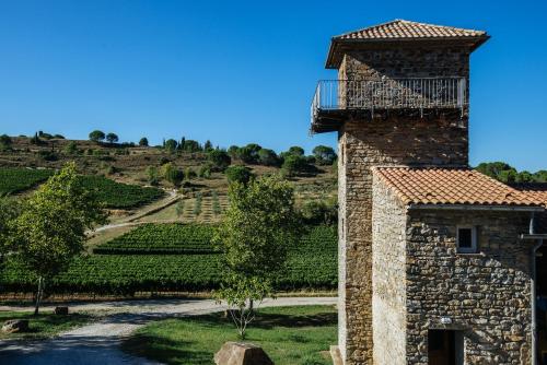 a stone building with a balcony on top of it at Domaine Calmel & Joseph in Montirat