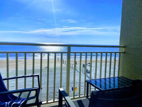 a balcony with a table and a view of the beach at Ocean View - Direct Ocean Front-Pool Is Open in Daytona Beach