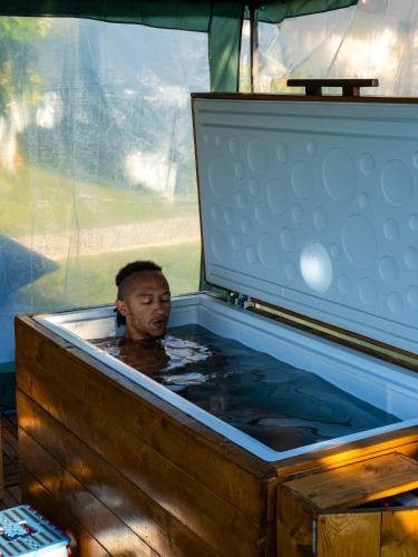 a man is sitting in a bath tub at Sukacita Hill in Uluwatu