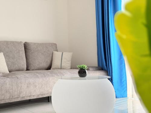 a living room with a couch and a table at The Sun Executive Suite - Dolphin's Home in Bayan Lepas