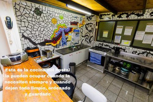 a kitchen with a mosaic tile wall with a sink at Hostal Pampaloja Antof in Antofagasta