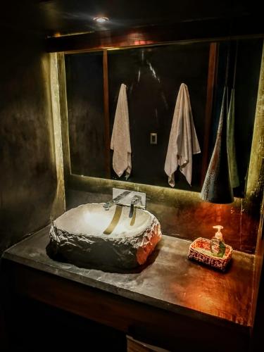a bathroom with a sink on a counter at Casa Vive Bacalar in Bacalar