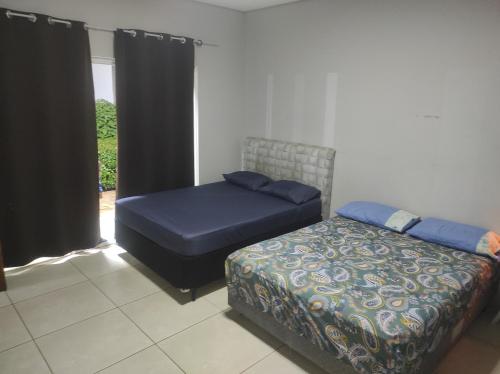 Postel nebo postele na pokoji v ubytování Recanto dos Amigos