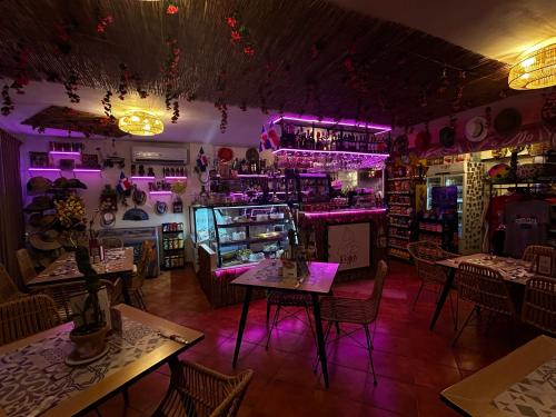 a room with tables and purple lighting in a restaurant at LAS PALMAS - DELUXE VILLAS and SUITES - playa LOS CORALES in Punta Cana