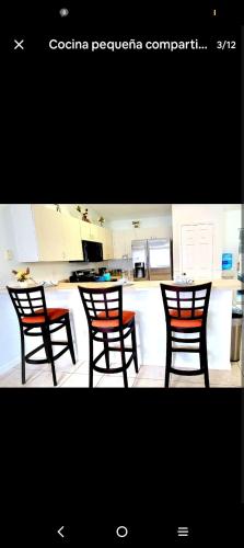 a kitchen with two chairs and a counter at BIG queen Bedroom with private full bathroom NEW ADDRESS 6571 sw 129 loop ocala FL 34473 in Ocala
