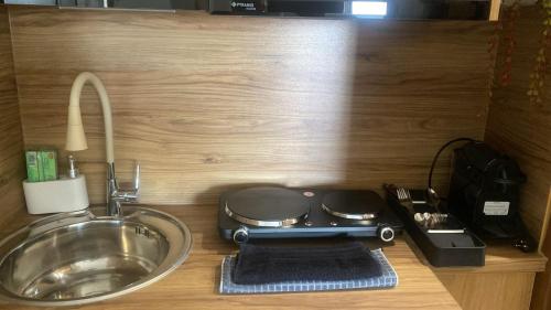 a kitchen counter with a stove and a sink at Central studio D1 Volos in Volos