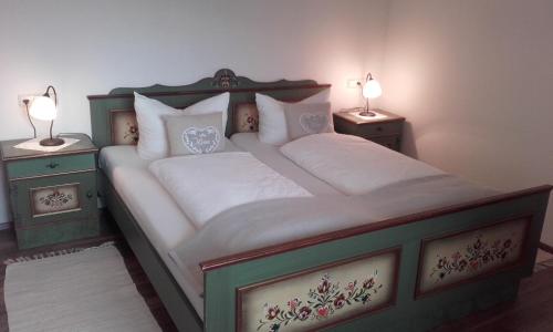 a bedroom with a large bed with two night stands at Pension Marillenhof in Melk