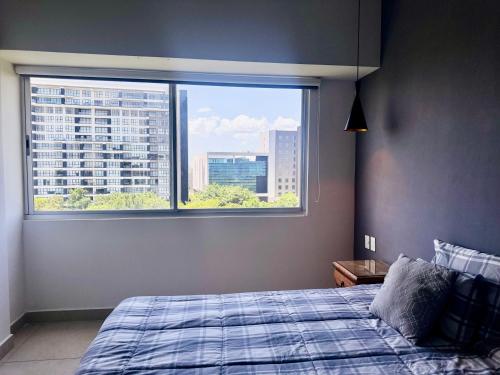 a bedroom with a bed and a large window at Vía Montejo, Mérida Yucatán in Mérida