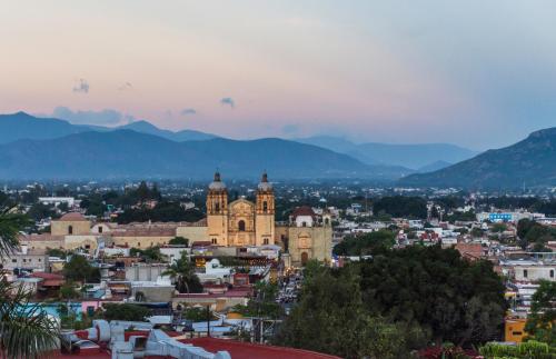a view of a city with mountains in the background at Casa Mayahuel in Oaxaca City