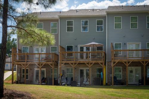 a large house with two decks on the front of it at Shoo Fly at Lake Oconee - Lakefront, Kayaks, Games in Eatonton