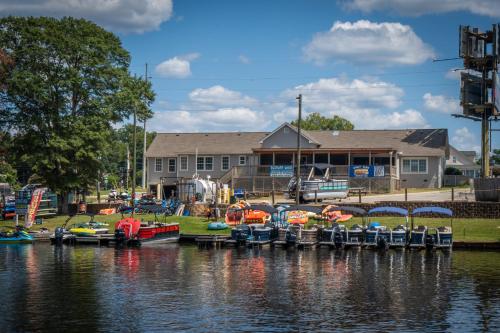 a group of boats parked at a dock on the water at Shoo Fly at Lake Oconee - Lakefront, Kayaks, Games in Eatonton