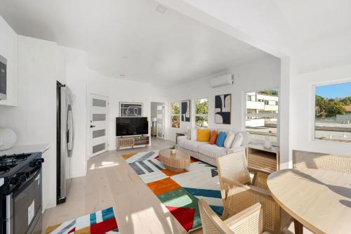 a living room with a couch and a table at Pacific Coast Suites - Oceanfront Living in Los Angeles